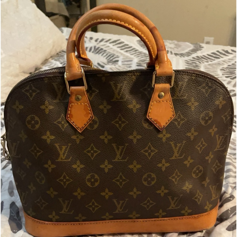 Authentic LV handbag has a stain on it No tears clean thru the inside